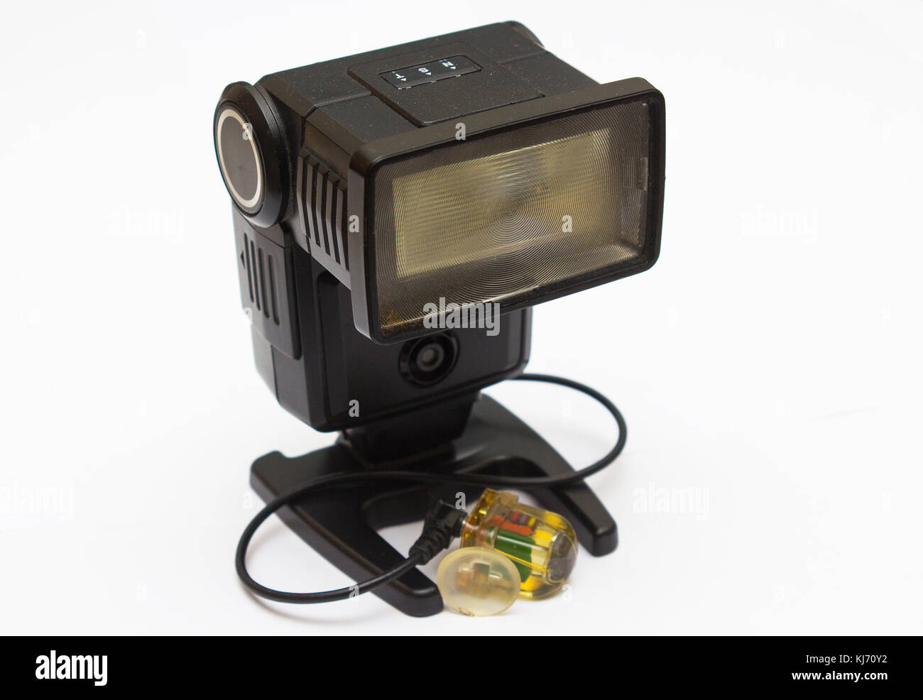 An old dusty National photographic flash unit from the film era that has been adapted for permanent use as a remote flash unit with a peanut slave fla Stock Photo