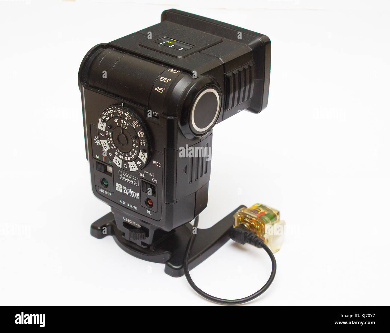 An old dusty National photographic flash unit from the film era that has been adapted for permanent use as a remote flash unit with a peanut slave fla Stock Photo