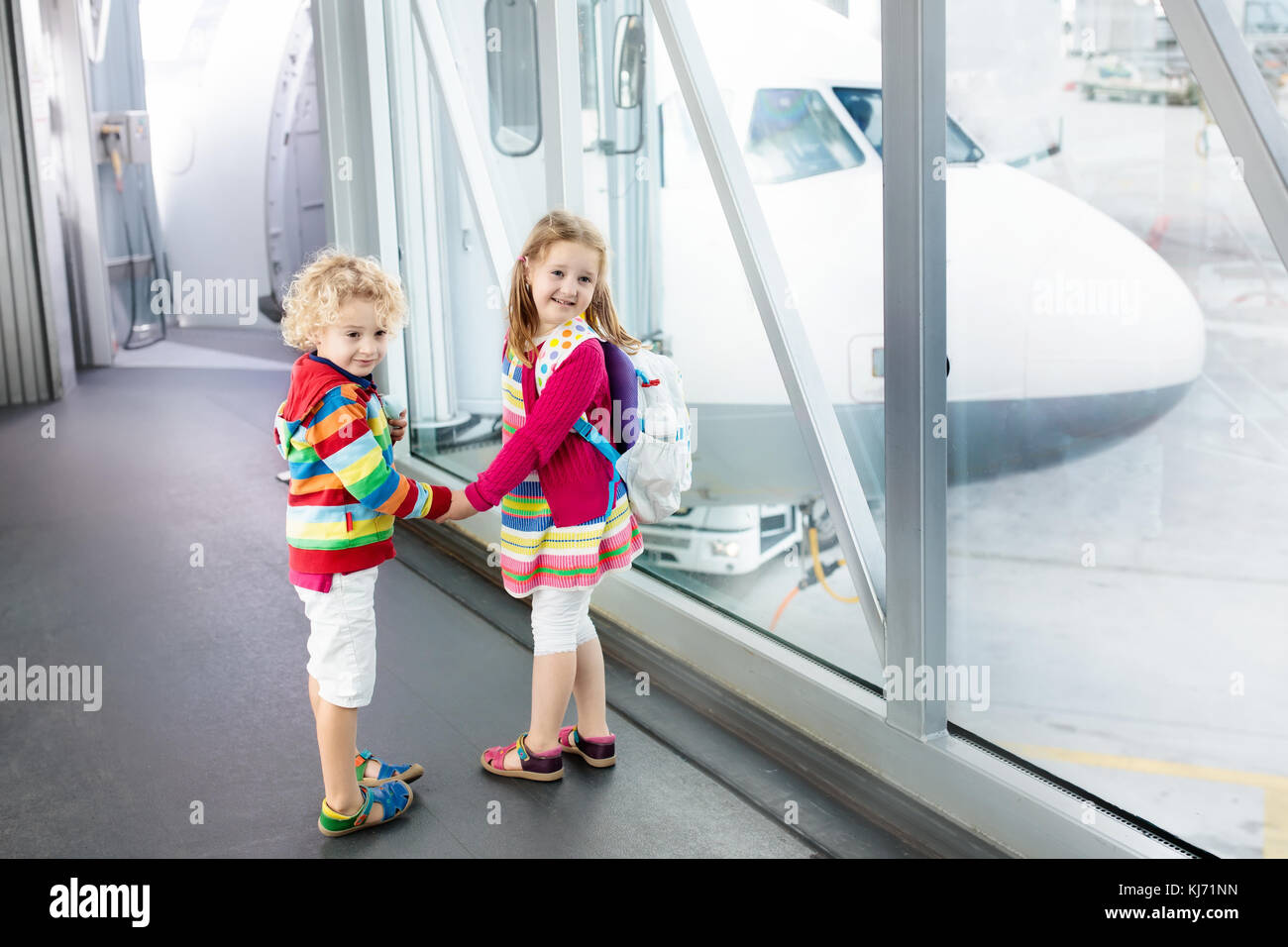 Kids At Airport Children Look At Airplane Traveling And Flying With kids-at-airport-children-look-at-airplane-traveling-and-flying-with