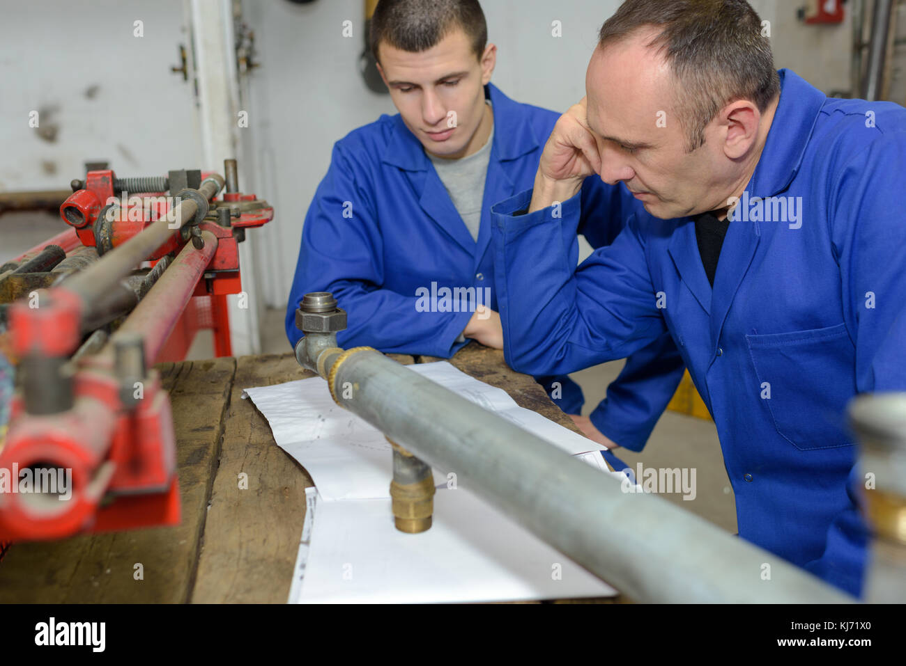 two worker in factory on the machine Stock Photo - Alamy