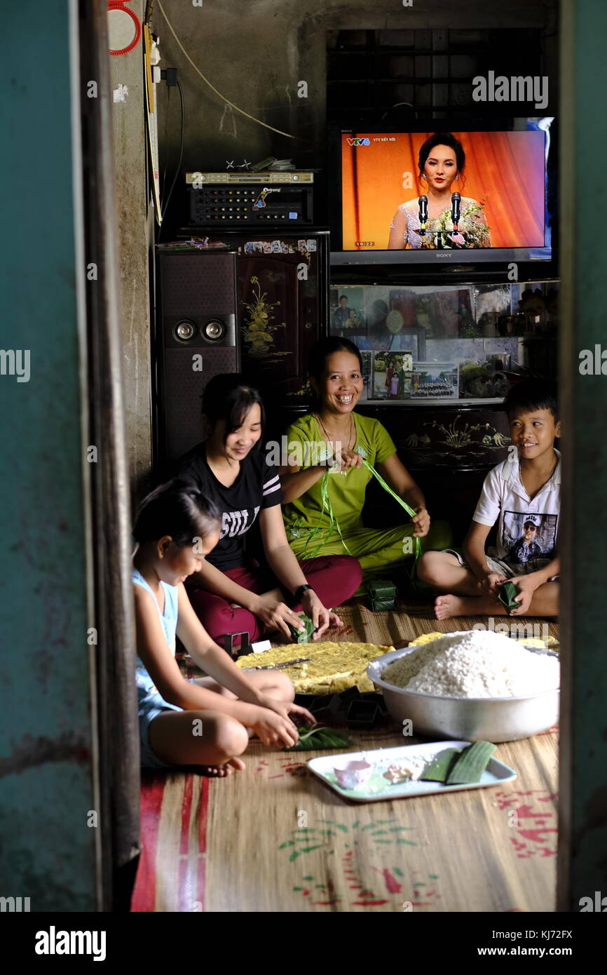 Vietnamese family preparing rice pancakes for market at home in a local village Stock Photo