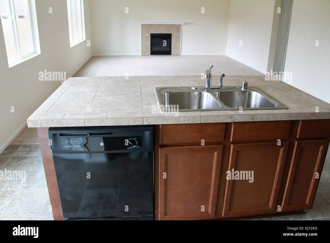 Empty kitchen and living room area in a new house Stock Photo - Alamy