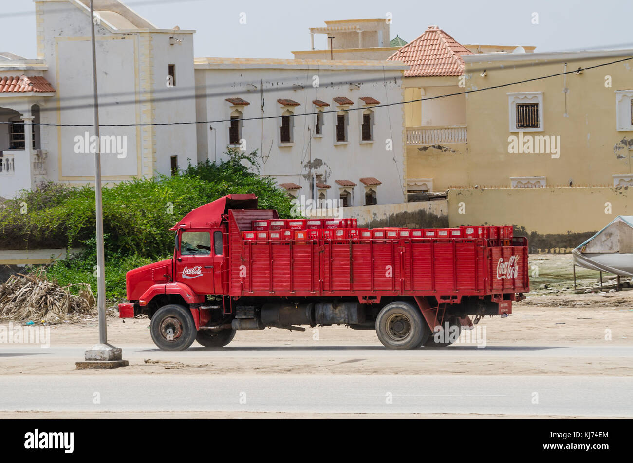 Nouakchott, Mauritania - October 08 2013: Old and classic Coca-Cola truck driving on dirt road in capital Stock Photo