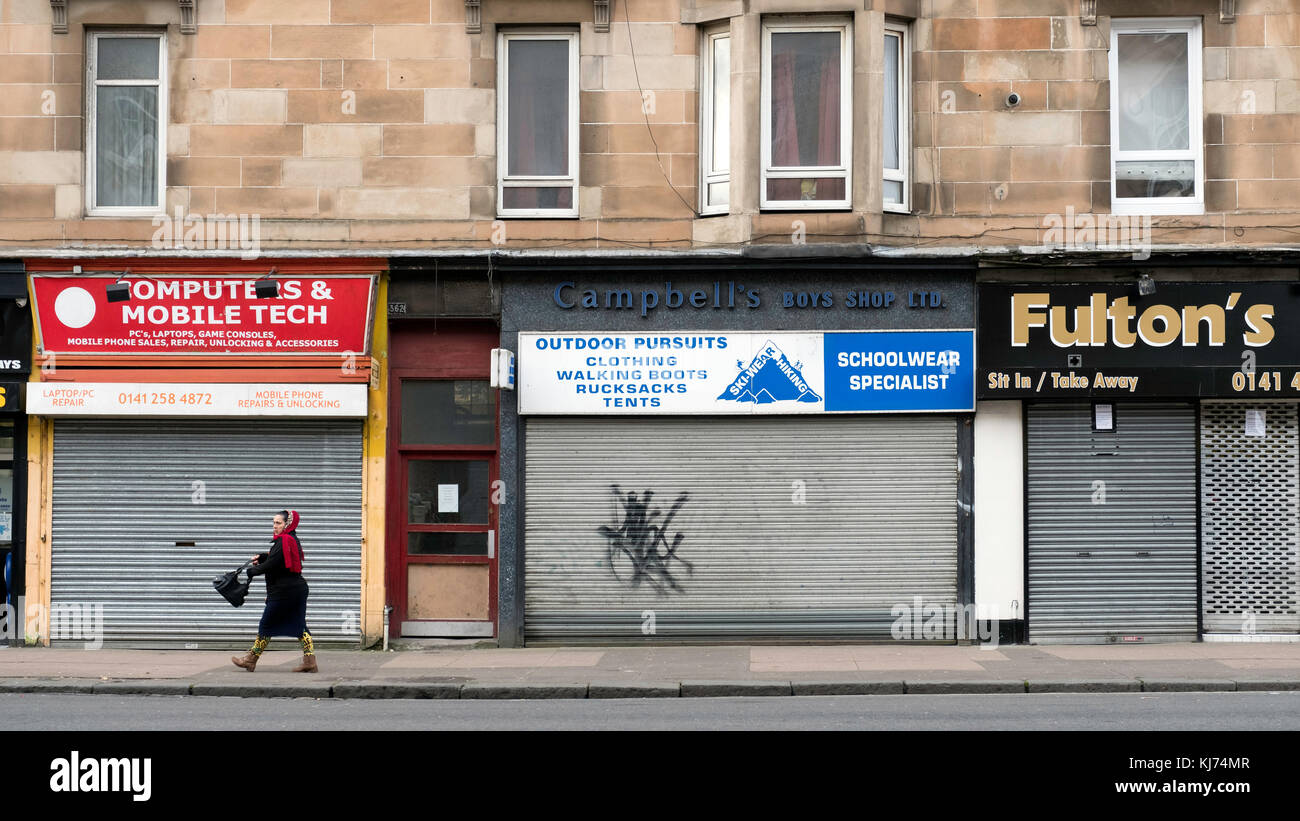 Closed shops with shutters down on Victoria Road in Govanhill district of Glasgow, Scotland, United Kingdom Stock Photo