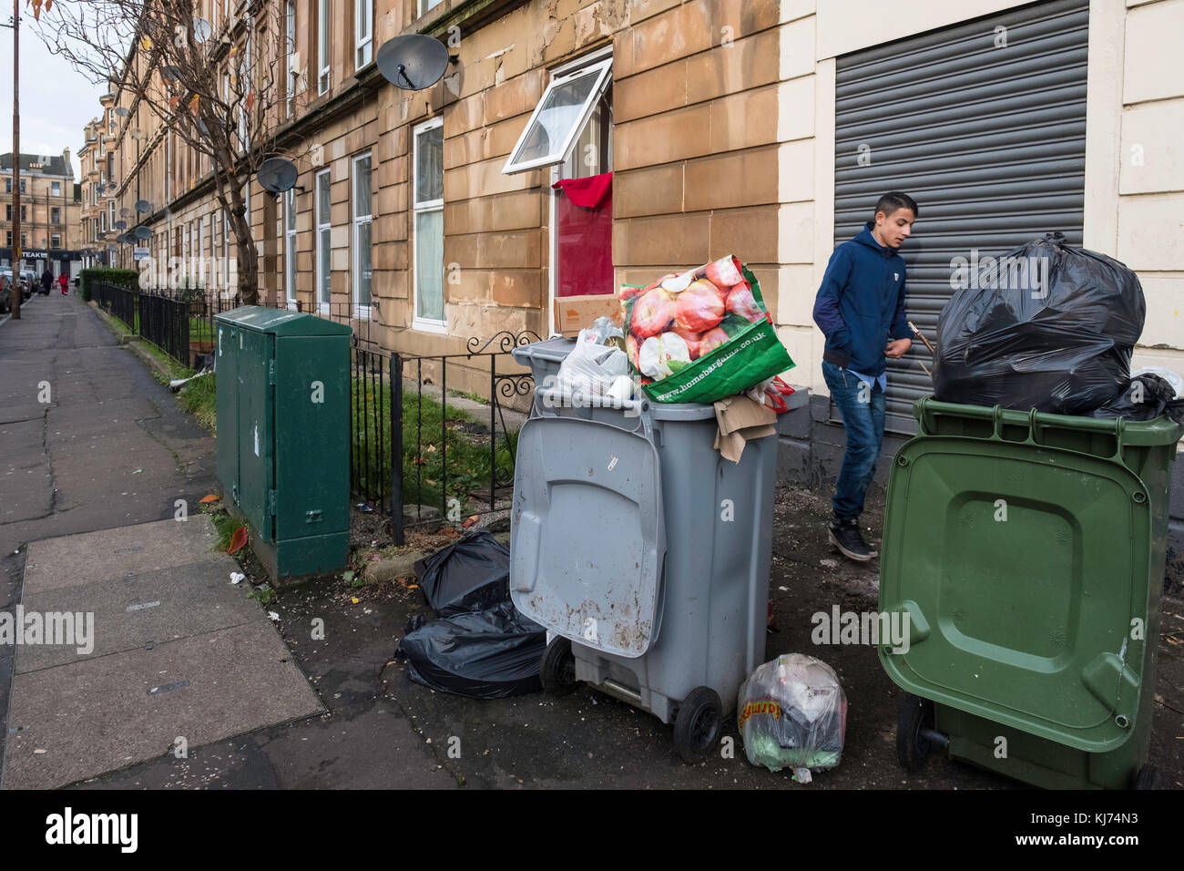 Bins full of rubbish on street in Govanhill district of Glasgow