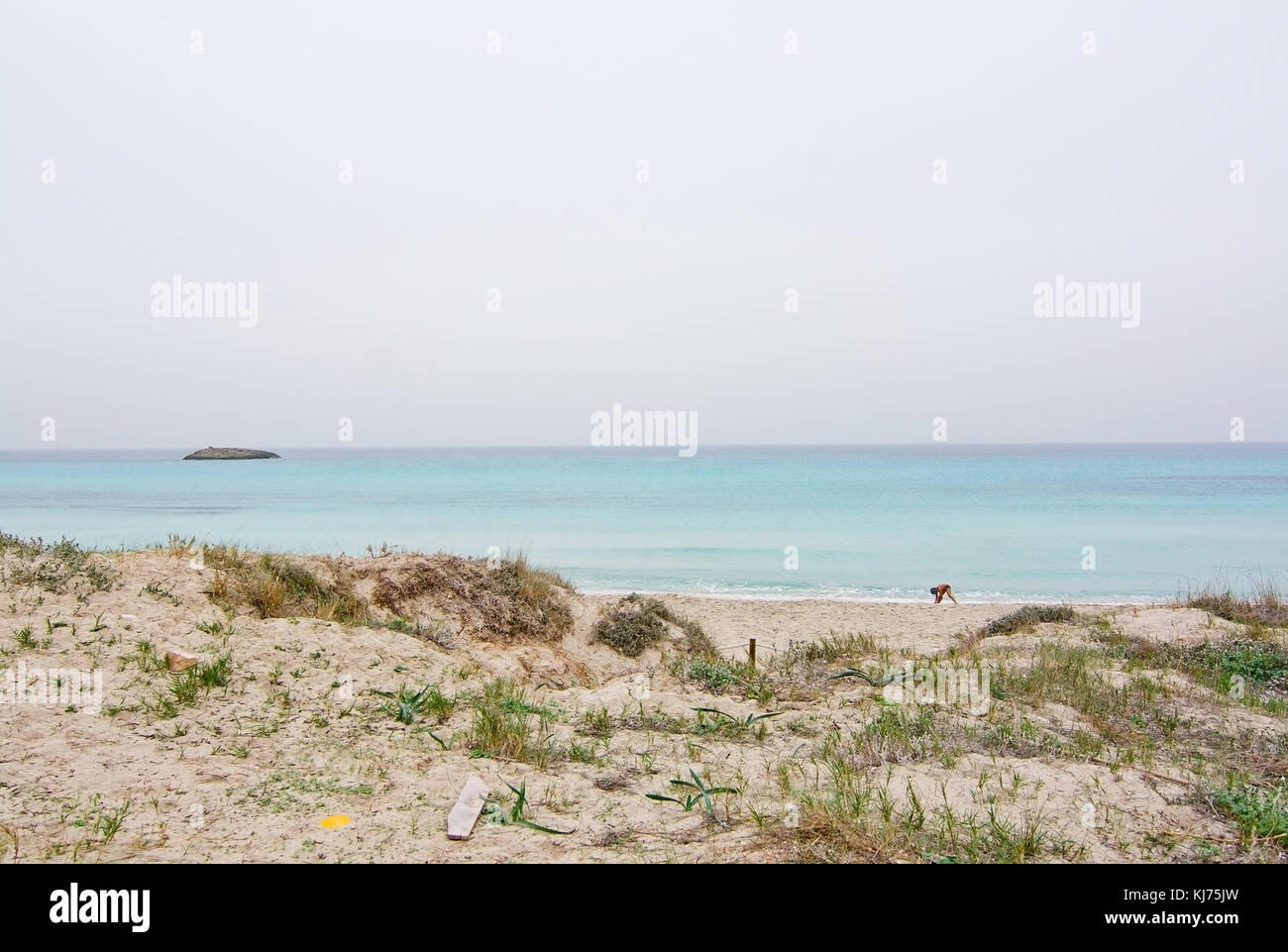 FORMENTERA, BALEARIC ISLANDS, SPAIN - OCTOBER 25, 2016: Dreamy soft paradise beach with crystal clear water on an overcast day on October 25, 2016 in  Stock Photo