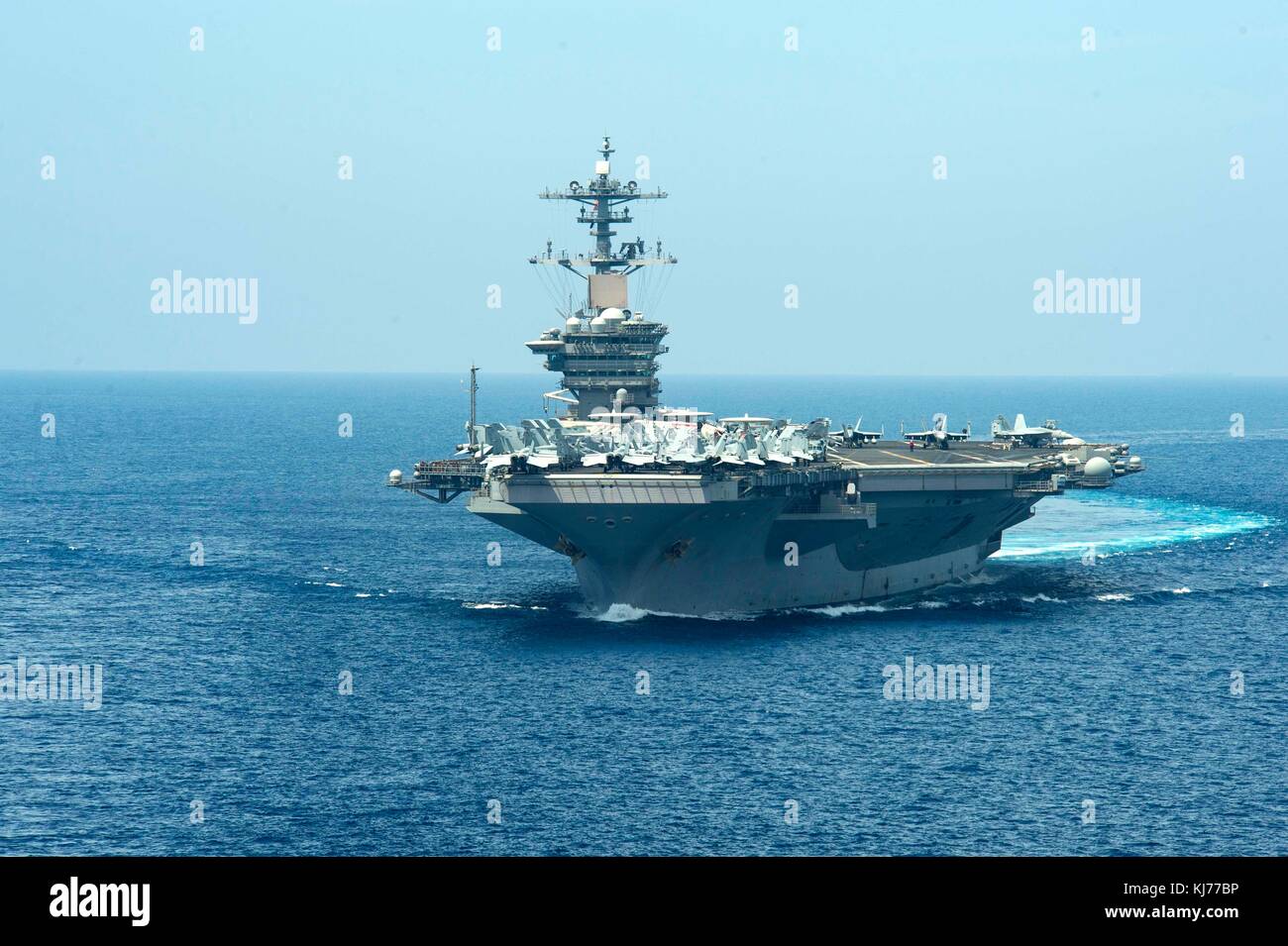 USS Theodore Roosevelt (CVN 76) maneuvers and approaches Military Sealift Command dry cargo and ammunition ship USNS Amelia Earhart (T-AKE 6) in the W Stock Photo