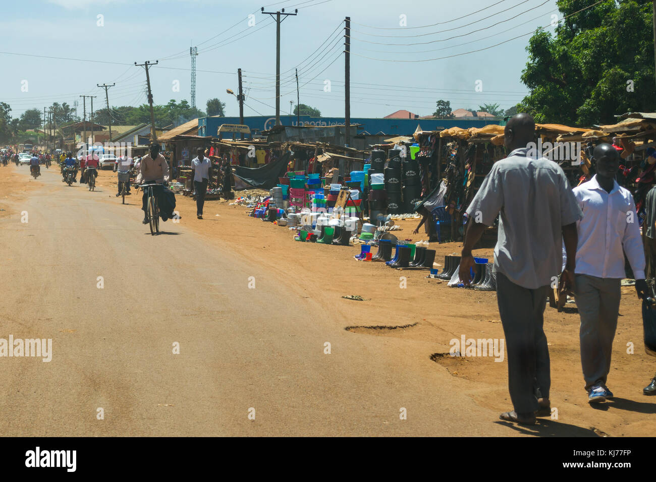 A busy street with market stalls lining it and people going about daily life, Busia, Uganda, East Africa Stock Photo