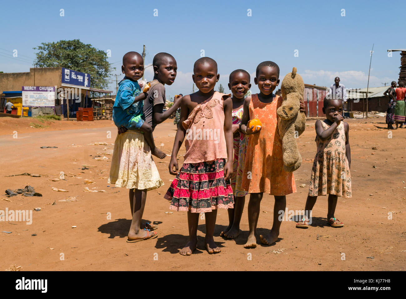 A group of young Ugandan children stand by the road posing for a photograph, Busia, Uganda, East Africa Stock Photo