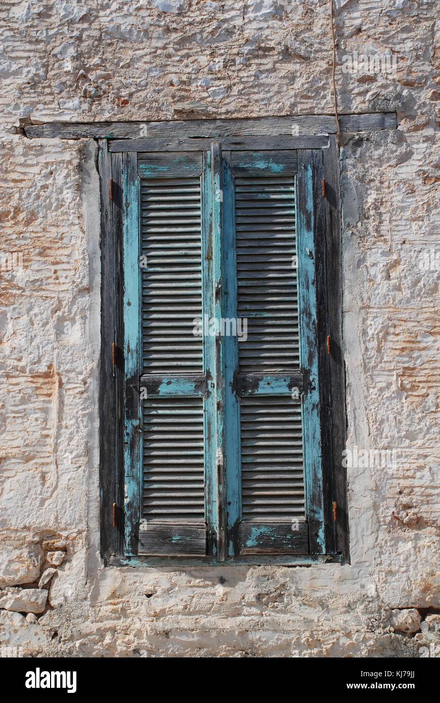 Closed wooden shutters on an old building at Emborio on the Greek island of Halki. Stock Photo
