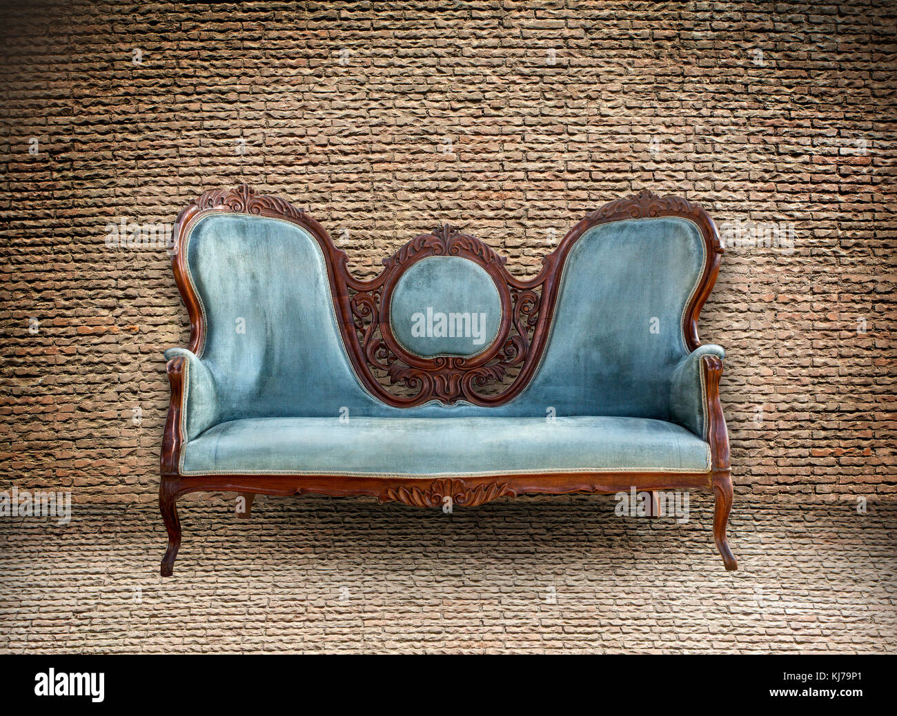 Background of old vintage brick wall and old vintage sofa Stock Photo