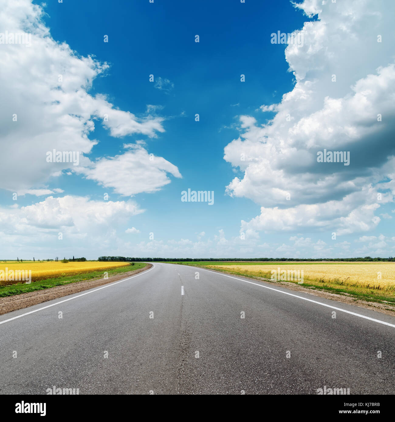 asphalt road under clouds in blue sky Stock Photo - Alamy