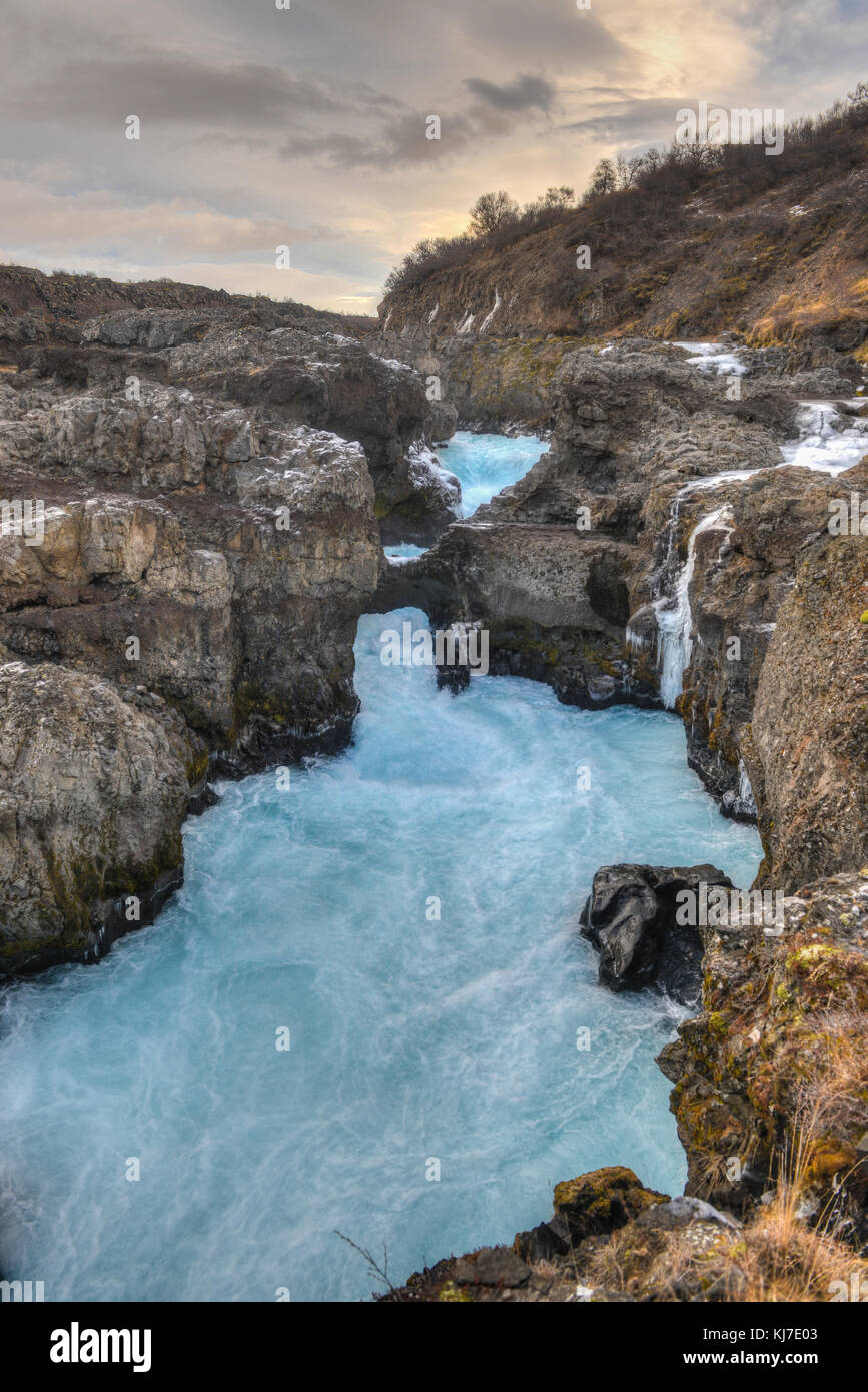 Glacial River Pool, Barnafoss, Iceland. Barnafoss, a waterfall, also known as Bjarnafoss, is near Hraunfossar which burst out of Hallmundarhraun which Stock Photo