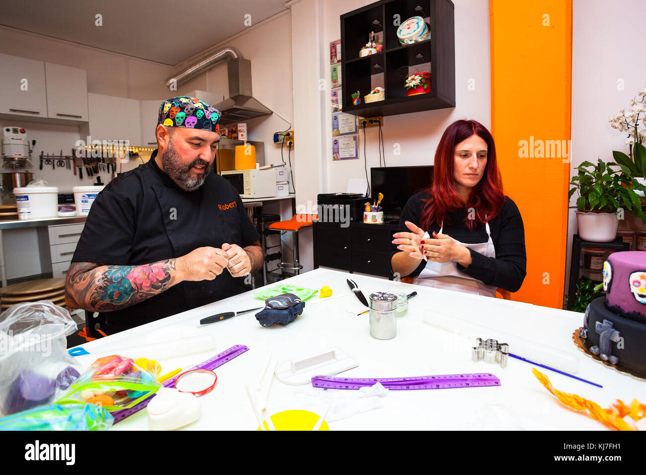 Pastry lesson, working on the figures of Halloween with fondant paste or sugar paste. Stock Photo