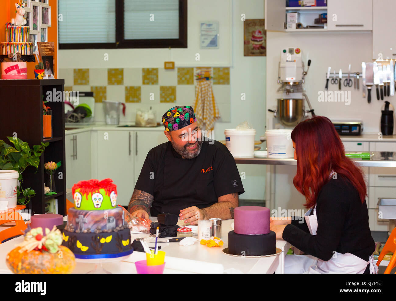 Pastry lesson, working on the figures of Halloween with fondant paste or sugar paste. Stock Photo