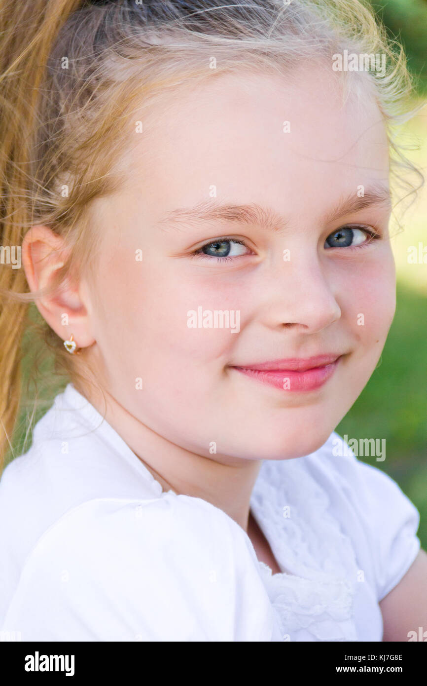 Cute girl with blond long hair and blue eyes Stock Photo - Alamy