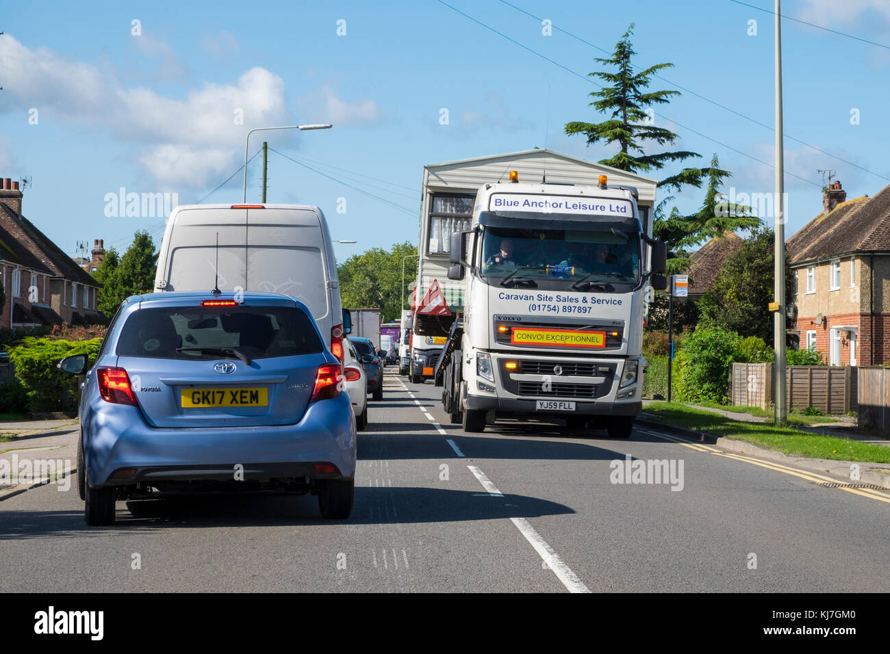 Truck with oversized load, mobile home. lorry relocates a caravan traveling on the A259 guldeford road in rye, uk Stock Photo
