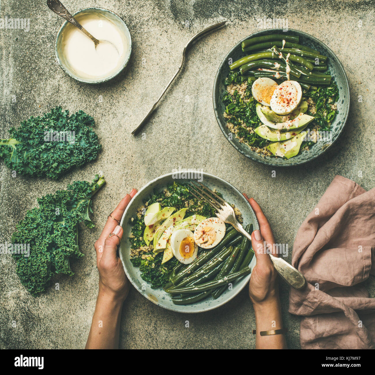 Flatlay of healthy vegetarian protein rich breakfast bowls. Quinoa, kale, green beans, avocado