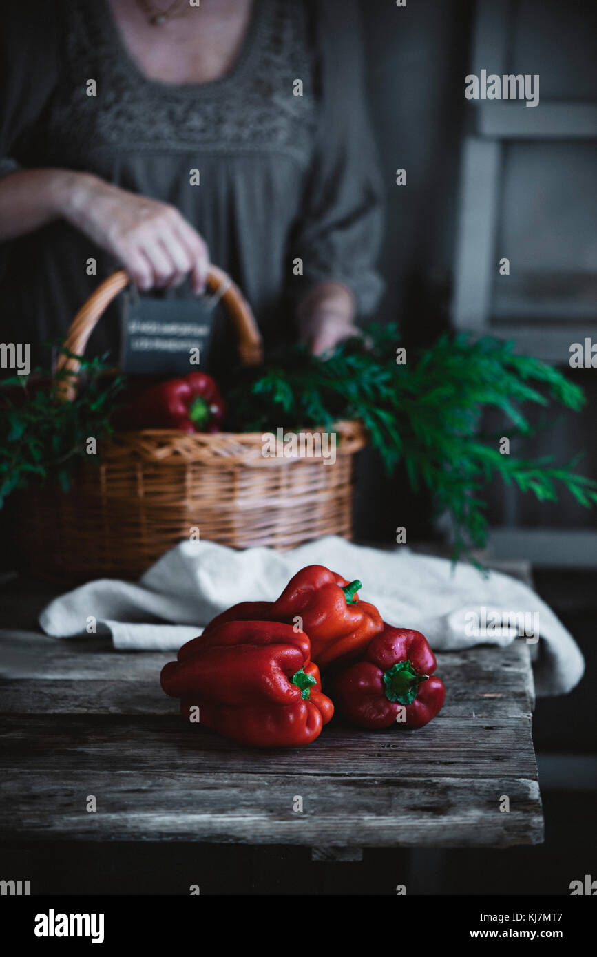 Red peppers on a rustic kitchen table Stock Photo - Alamy