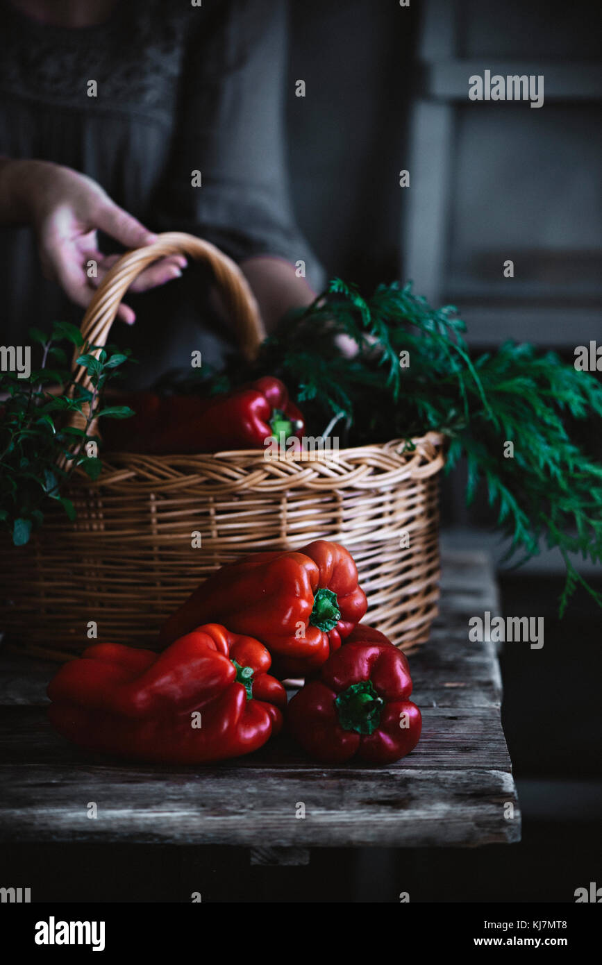 Red peppers on a rustic kitchen table Stock Photo - Alamy