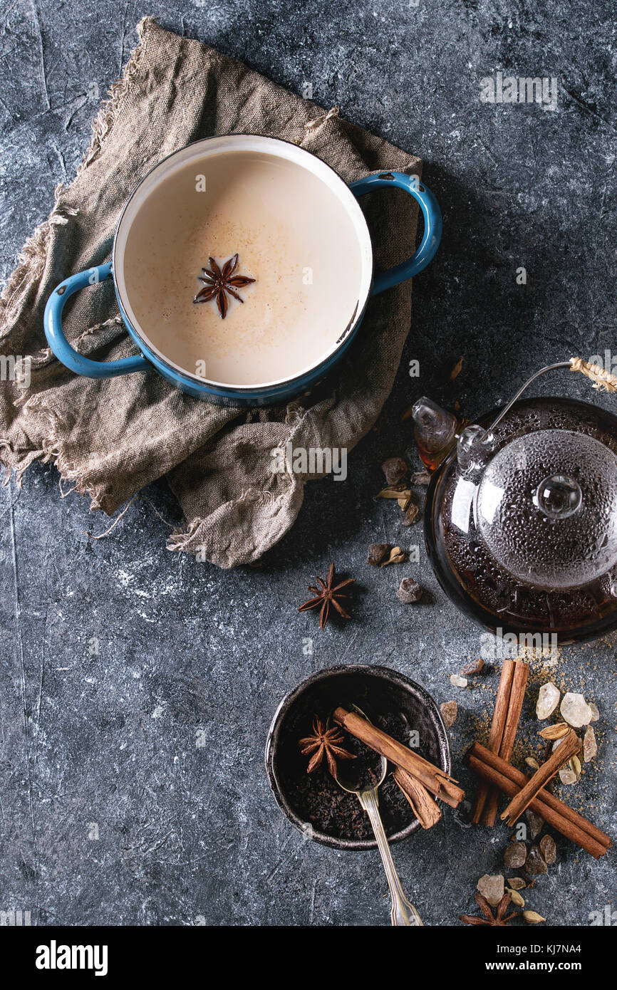 Vintage blue pot of traditional indian masala chai tea with ingredients ...