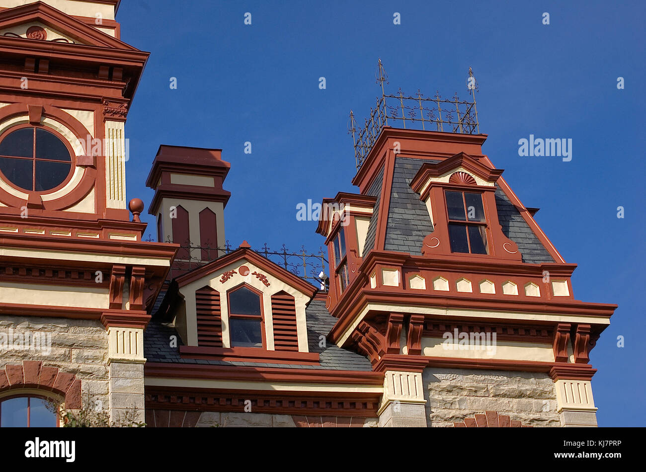 Roof windows and gables of an old rock courthouse building Stock Photo