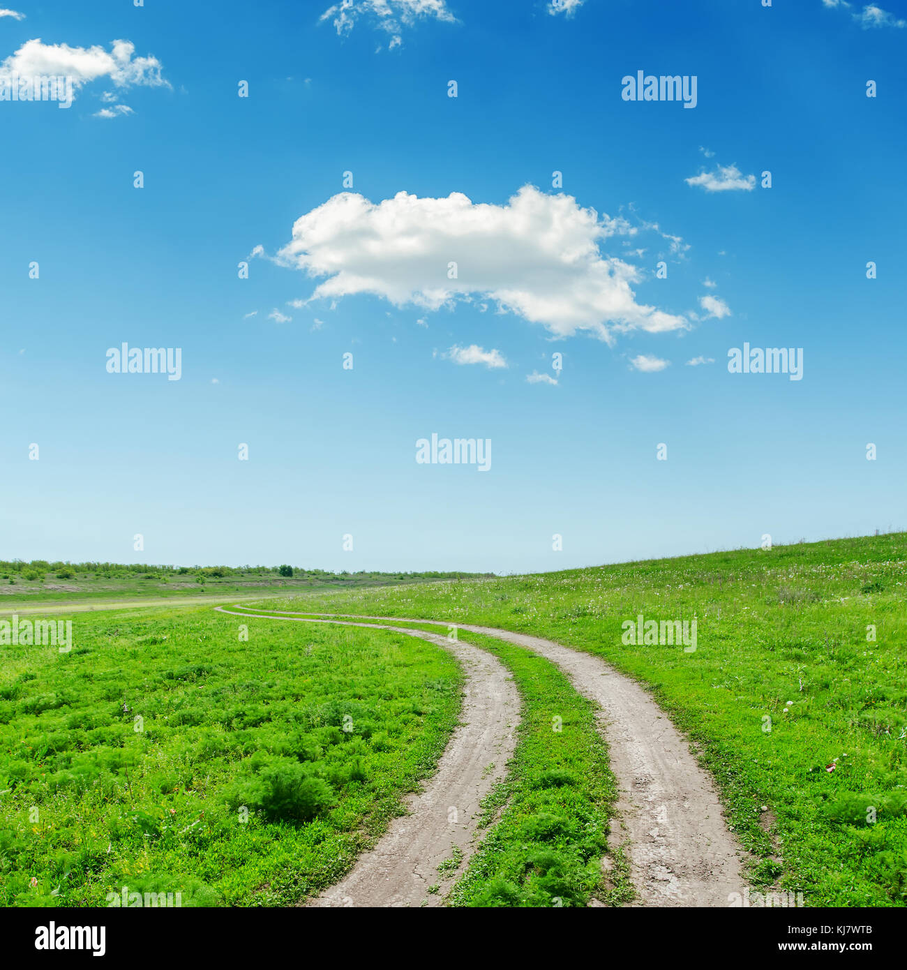 road in green grass and clouds in blue sky Stock Photo - Alamy