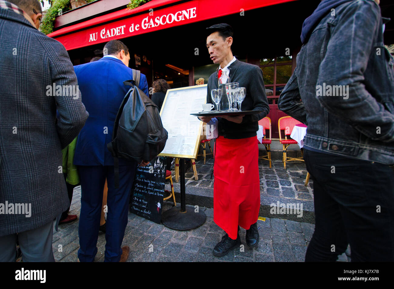 Paris, France. Montmartre - Place du Tertre - Asian waiter Stock Photo