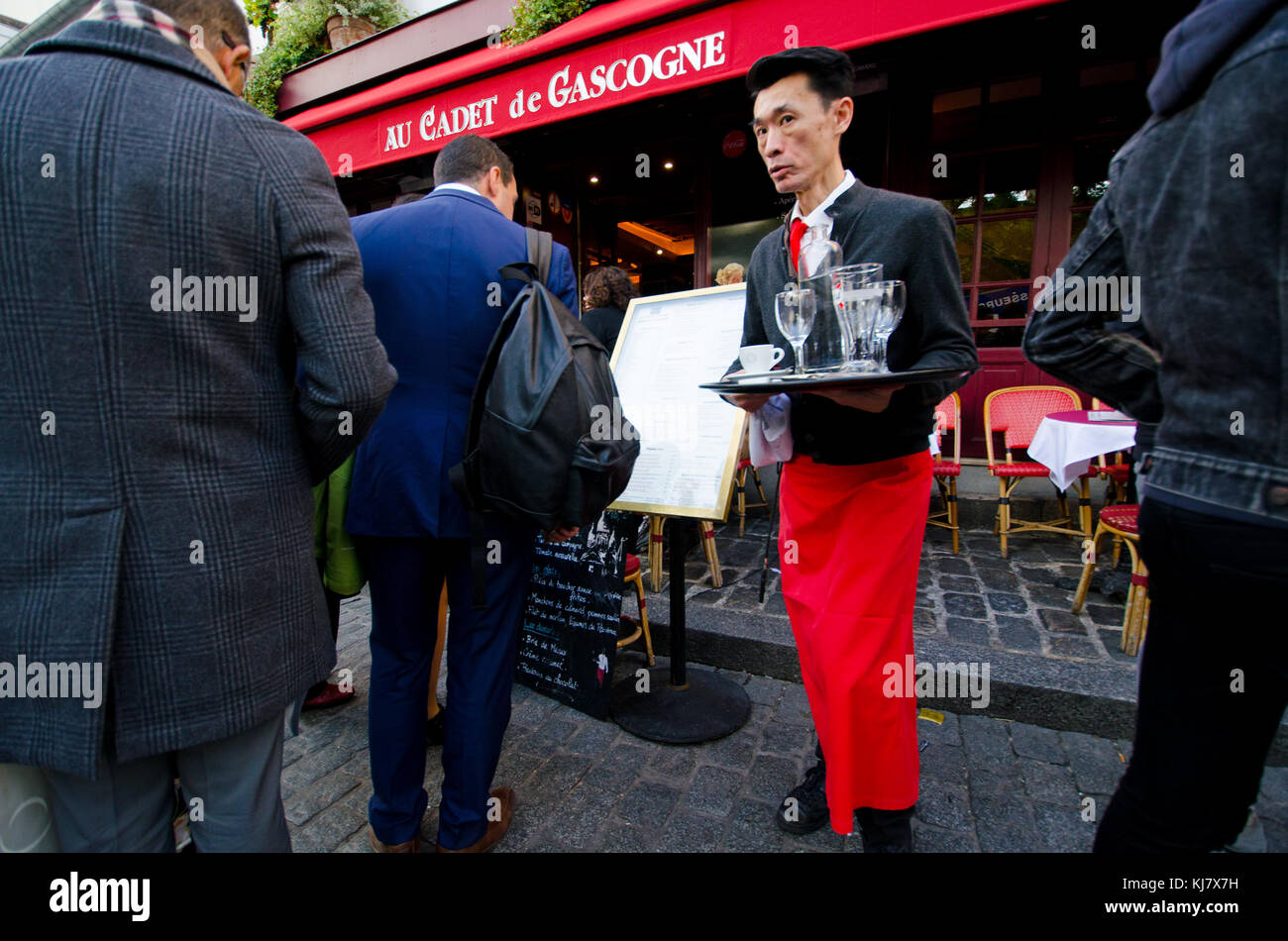 Paris, France. Montmartre - Place du Tertre - Asian waiter Stock Photo