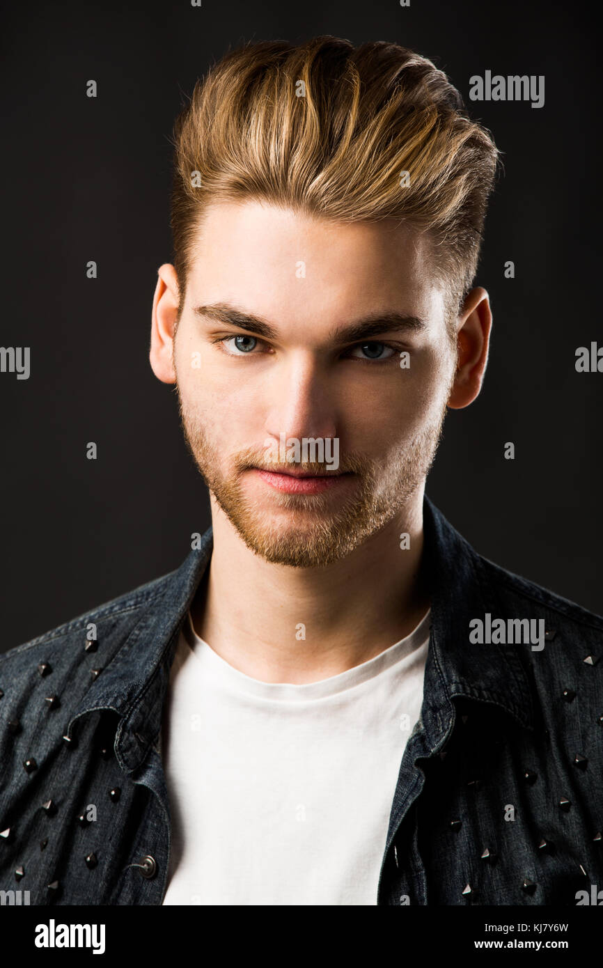 Portrait of a handsome young man, isolated over a gray background Stock ...