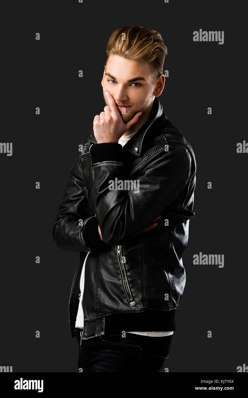 Portrait of a handsome young man, isolated over a gray background Stock ...