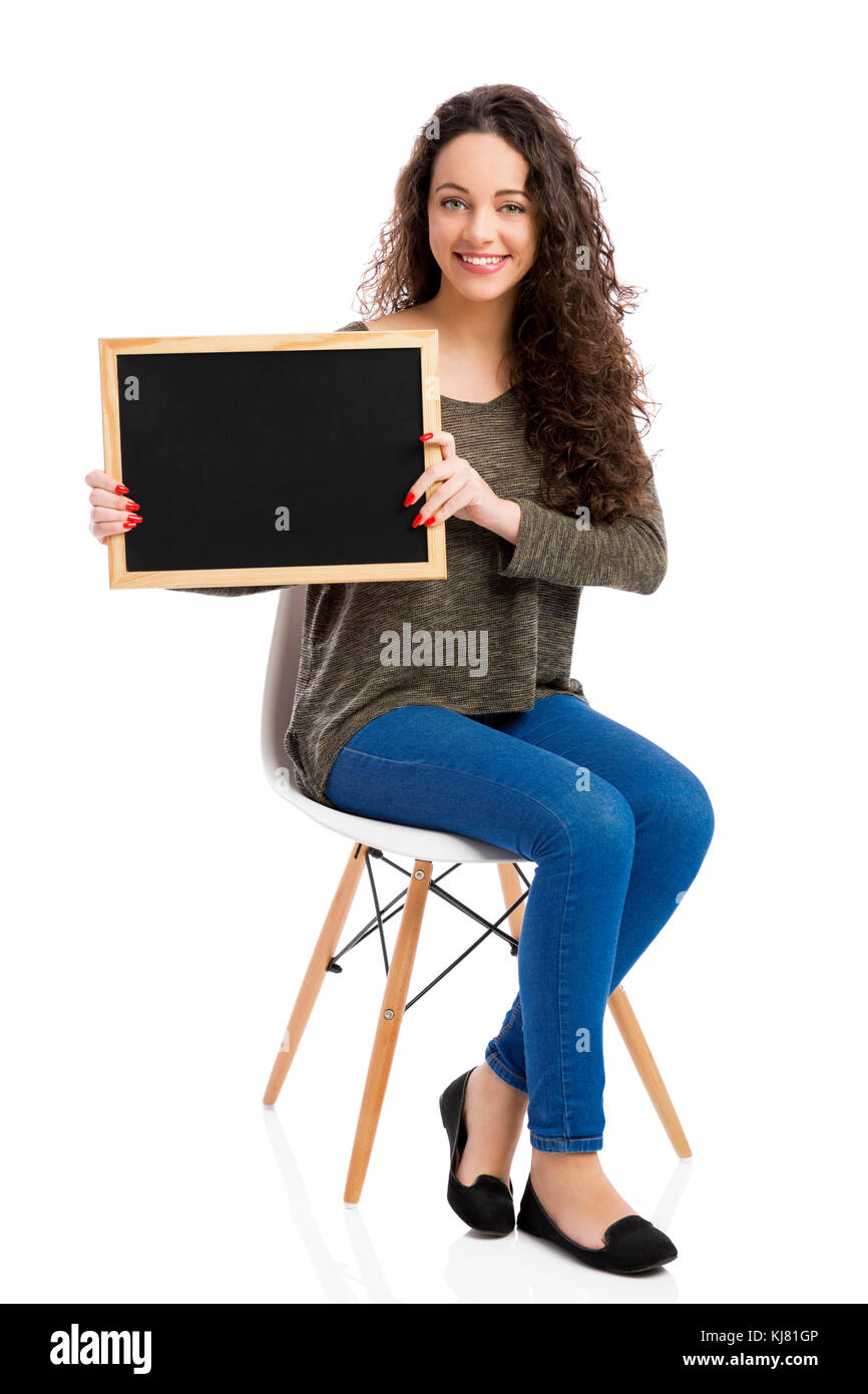 Beautiful and happy woman showing something on a chalkboard Stock Photo