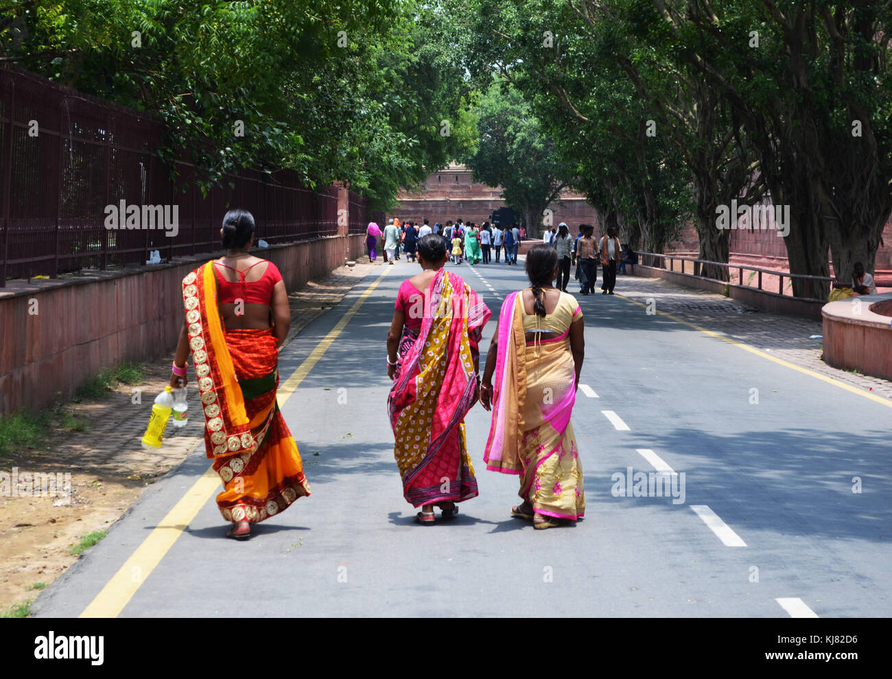 People walking along road next to Red Fort Delhi India Stock Photo
