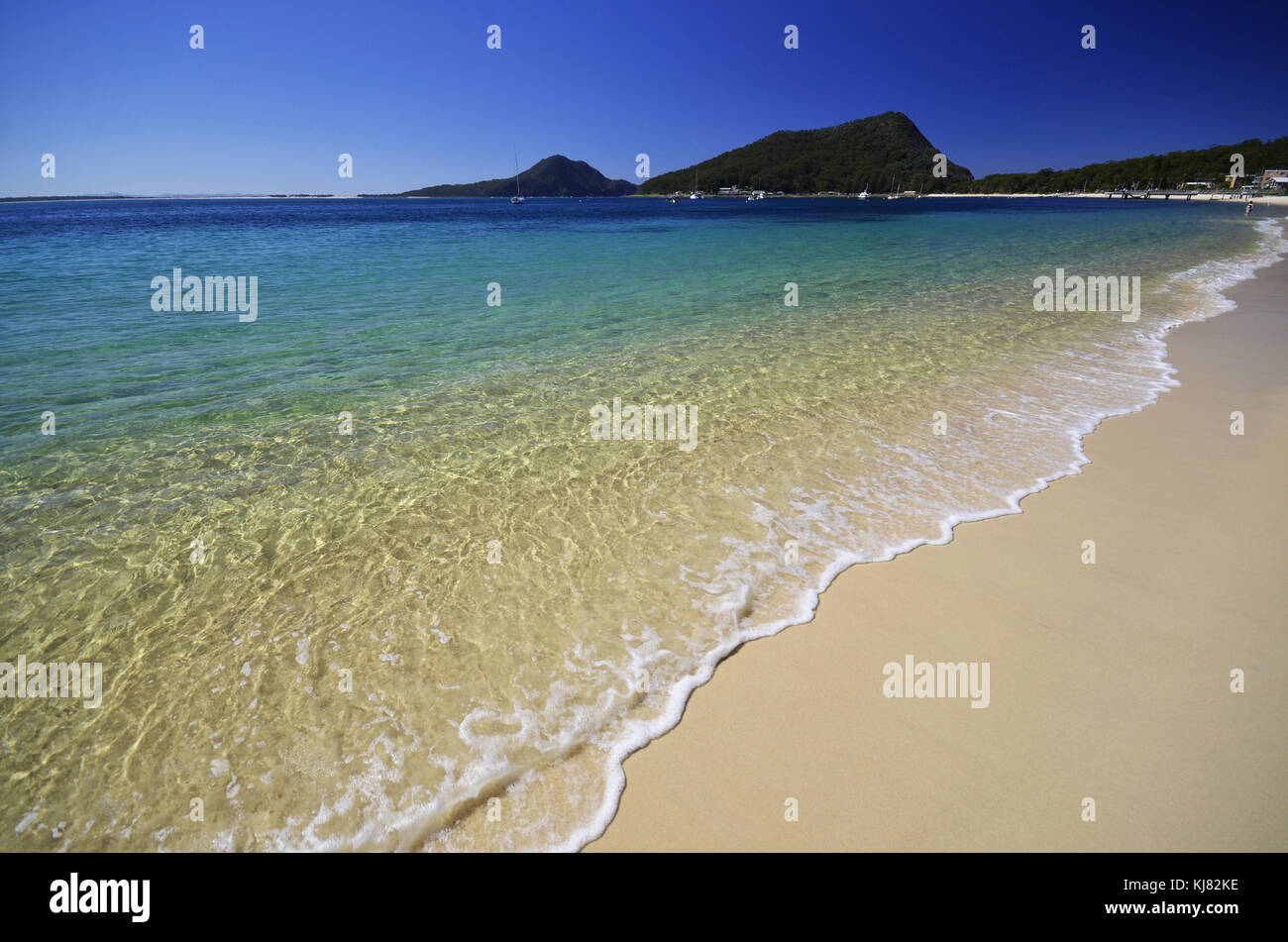 Shoal Bay NSW Australia. View along beach towards Mount Tomaree at