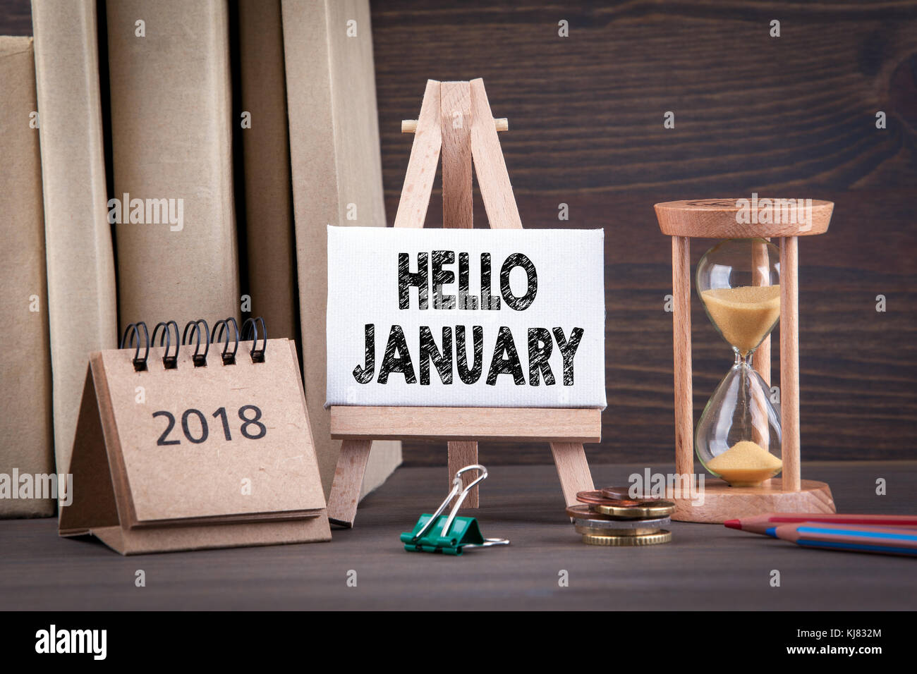 hello january. Sandglass, hourglass or egg timer on wooden table  Stock Photo