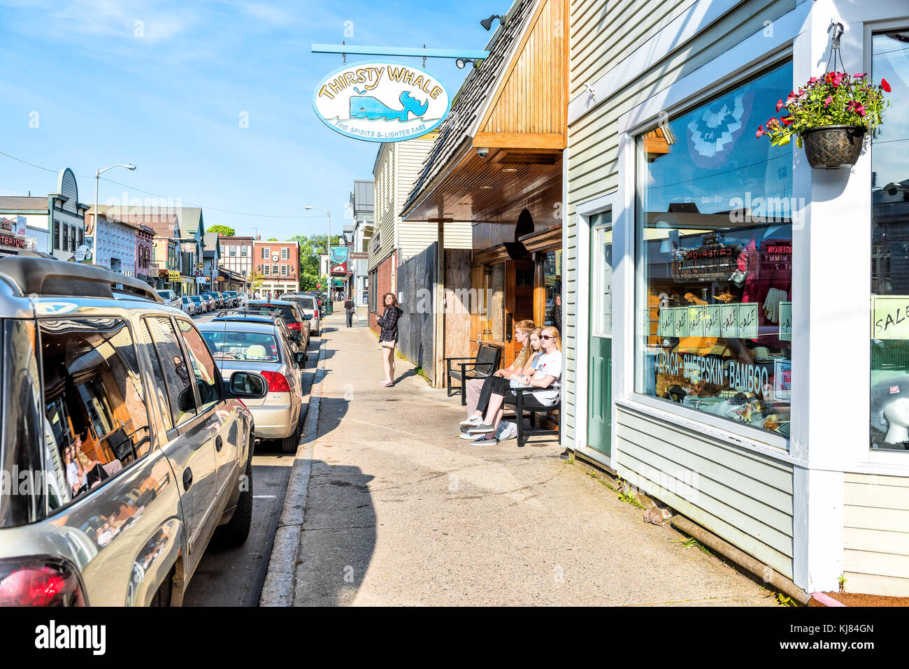 Bar Harbor, USA - June 8, 2017: People walking relaxing on sidewalk in downtown village on Mount Desert Island in New England on vacation in summer by Stock Photo