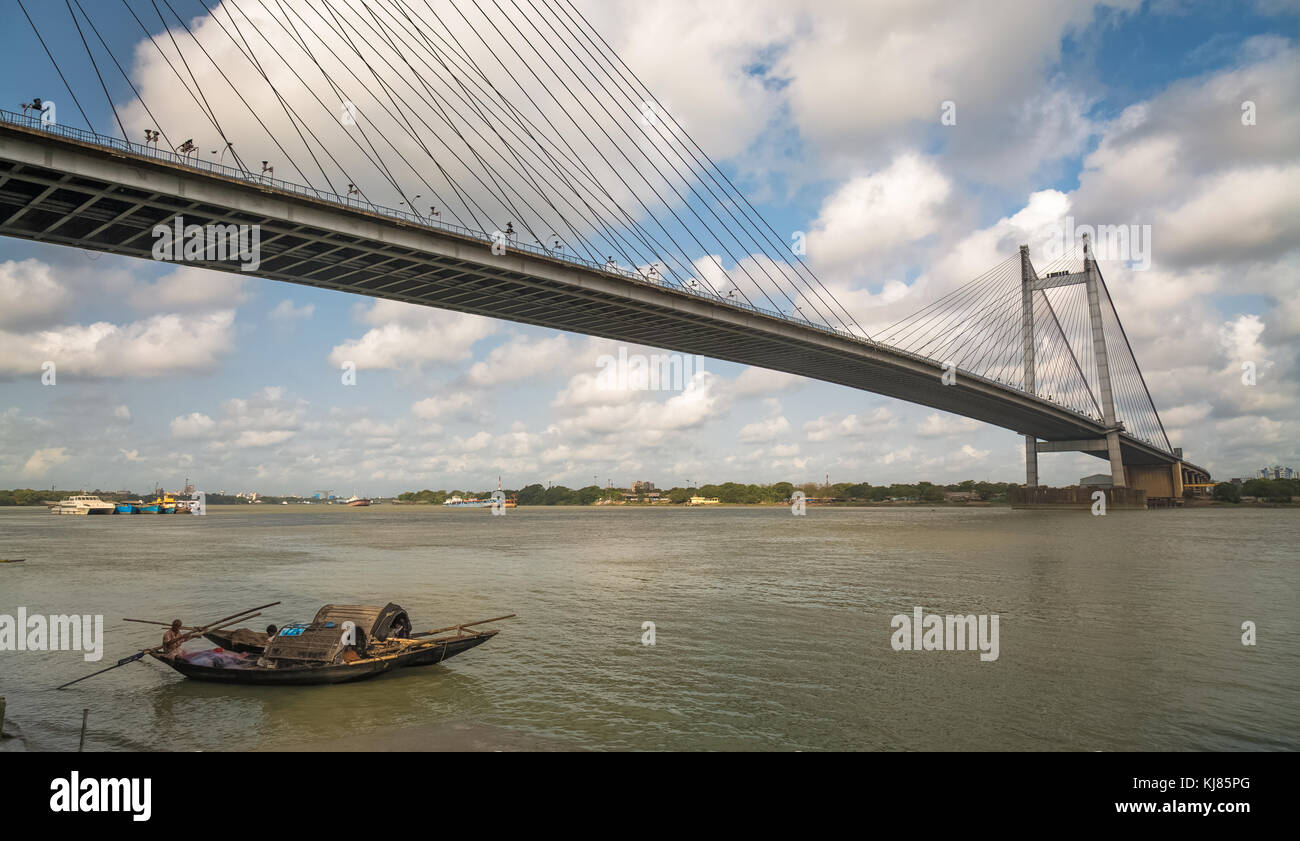 Vidyasagar Setu - The cable stayed bridge on river Hooghly with wooden boats. Photograph taken from Princep Ghat Kolkata, India Stock Photo