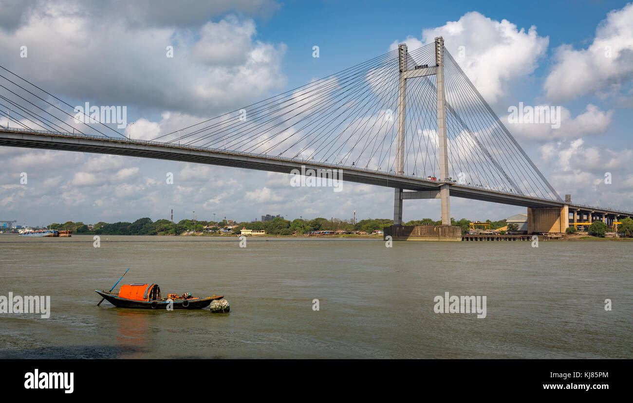 Vidyasagar Setu - The cable stayed bridge on river Hooghly with wooden boats. Photograph taken from Princep Ghat Kolkata, India Stock Photo