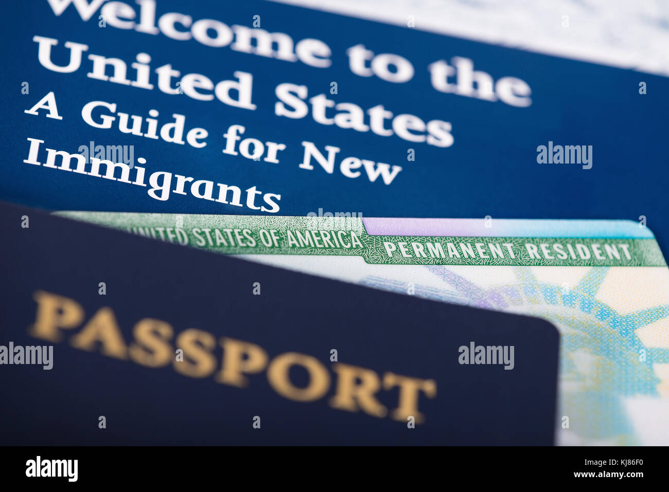 United States of America permanent resident card, green card, displayed with a passport. Immigration concept. Close up with shallow depth of field. Stock Photo
