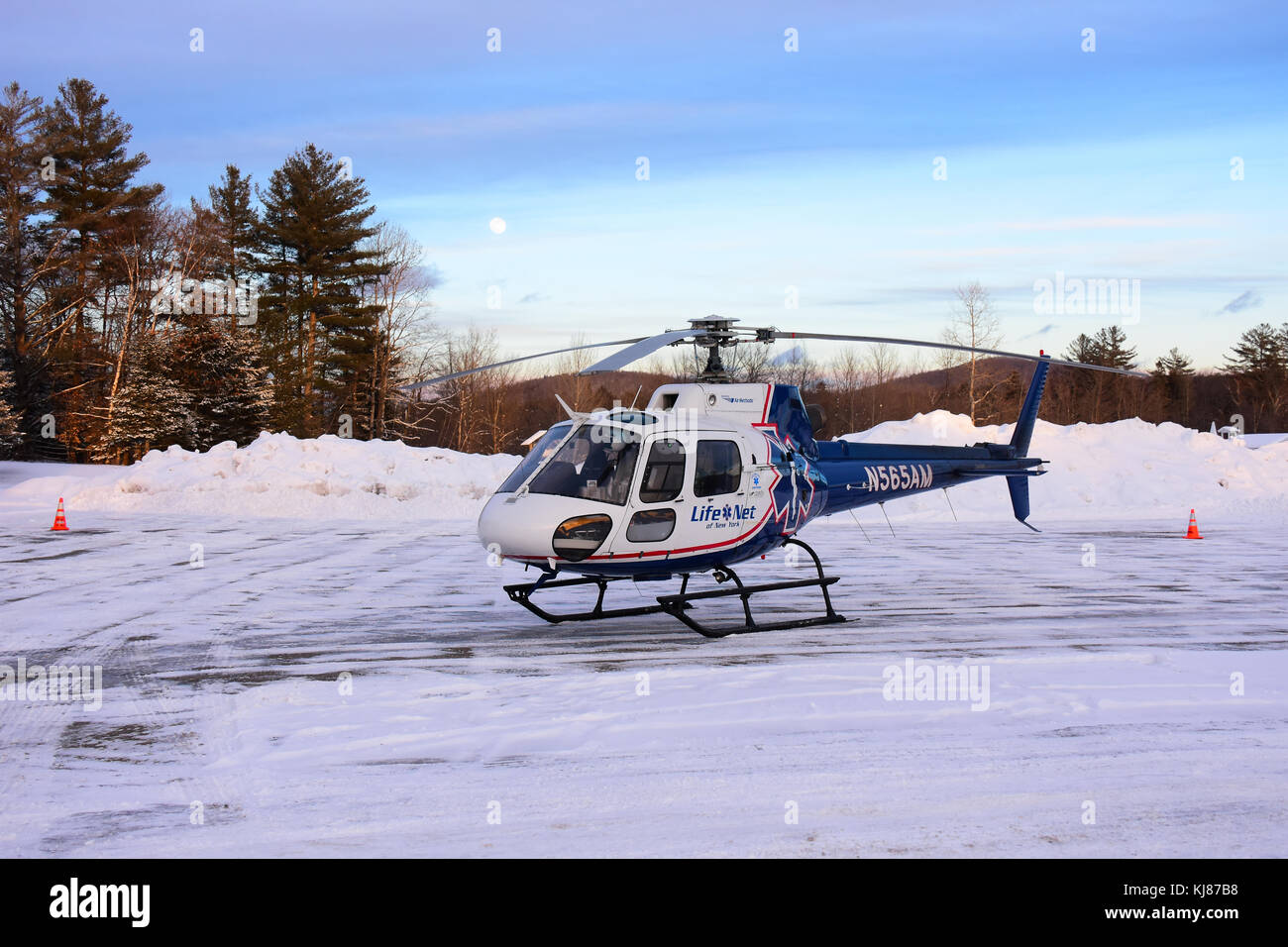 Medical evacuation helicopter parked on a helipad in the snow in