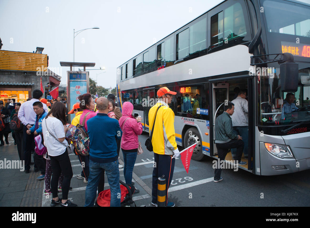 People stand in line for buses near Tiananmen Square in Beijing. Stock Photo