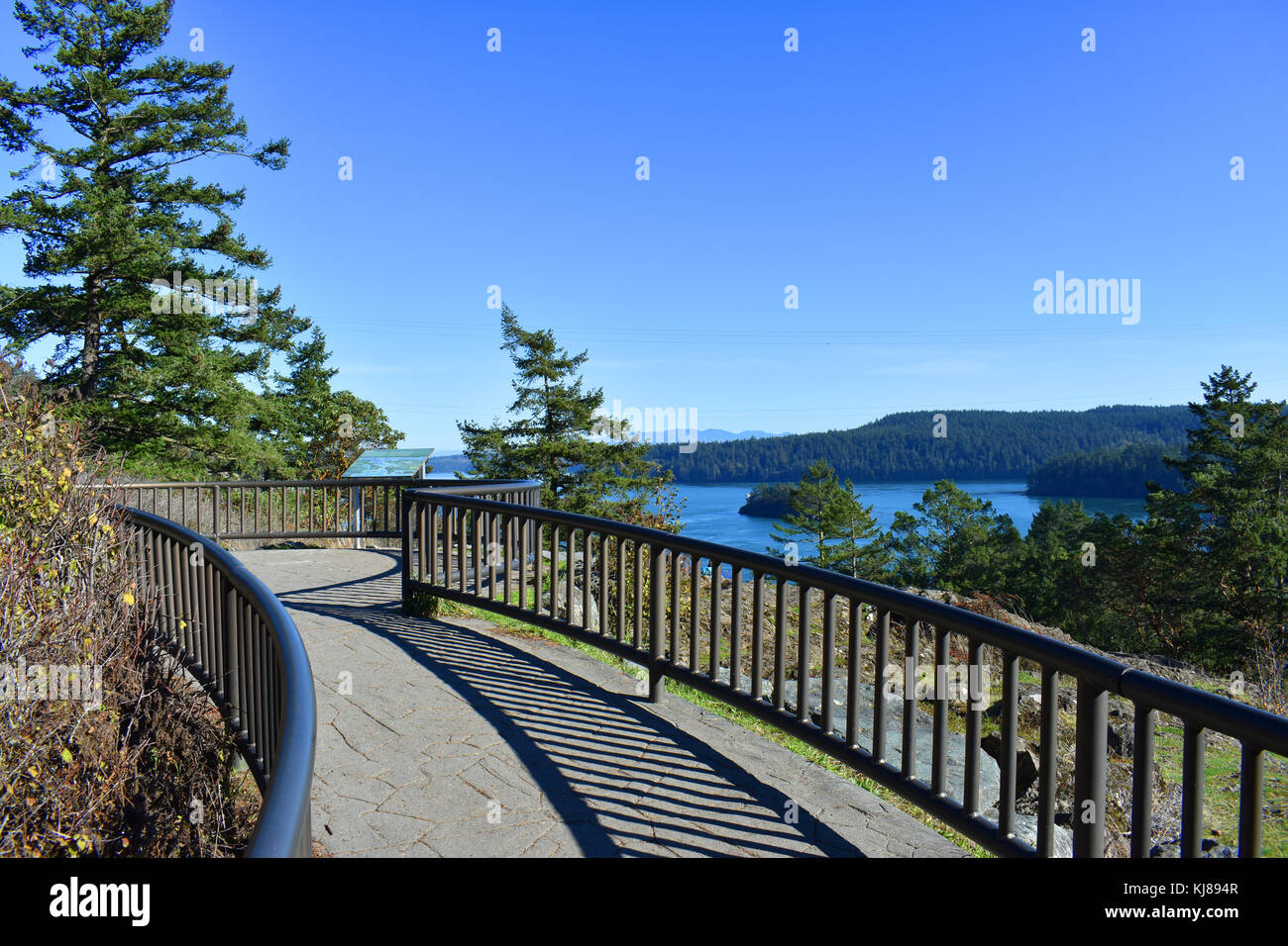 Walkway to the viewpoint at Deception Pass where a map rests in front of the scenic overlook. Stock Photo
