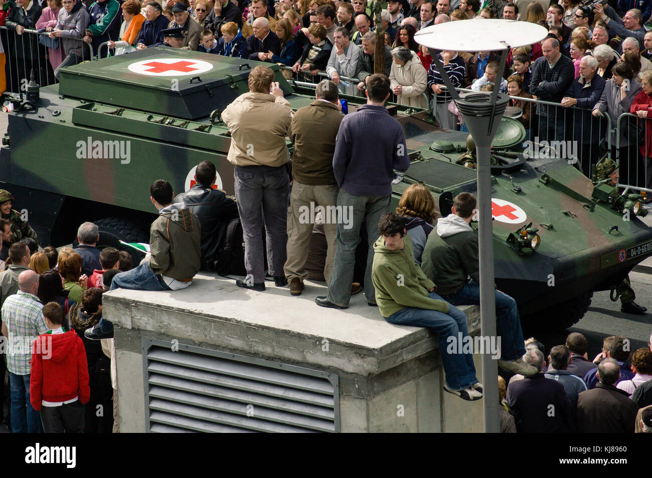 Crowds watching Irish Military Forces parade at the 1916 Easter Rising commemoration on O`Connell Street in Dublin, Ireland Stock Photo