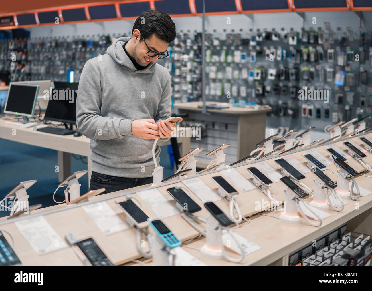 Some Android Customer Happy male customer choosing smartphone Stock Photo - Alamy