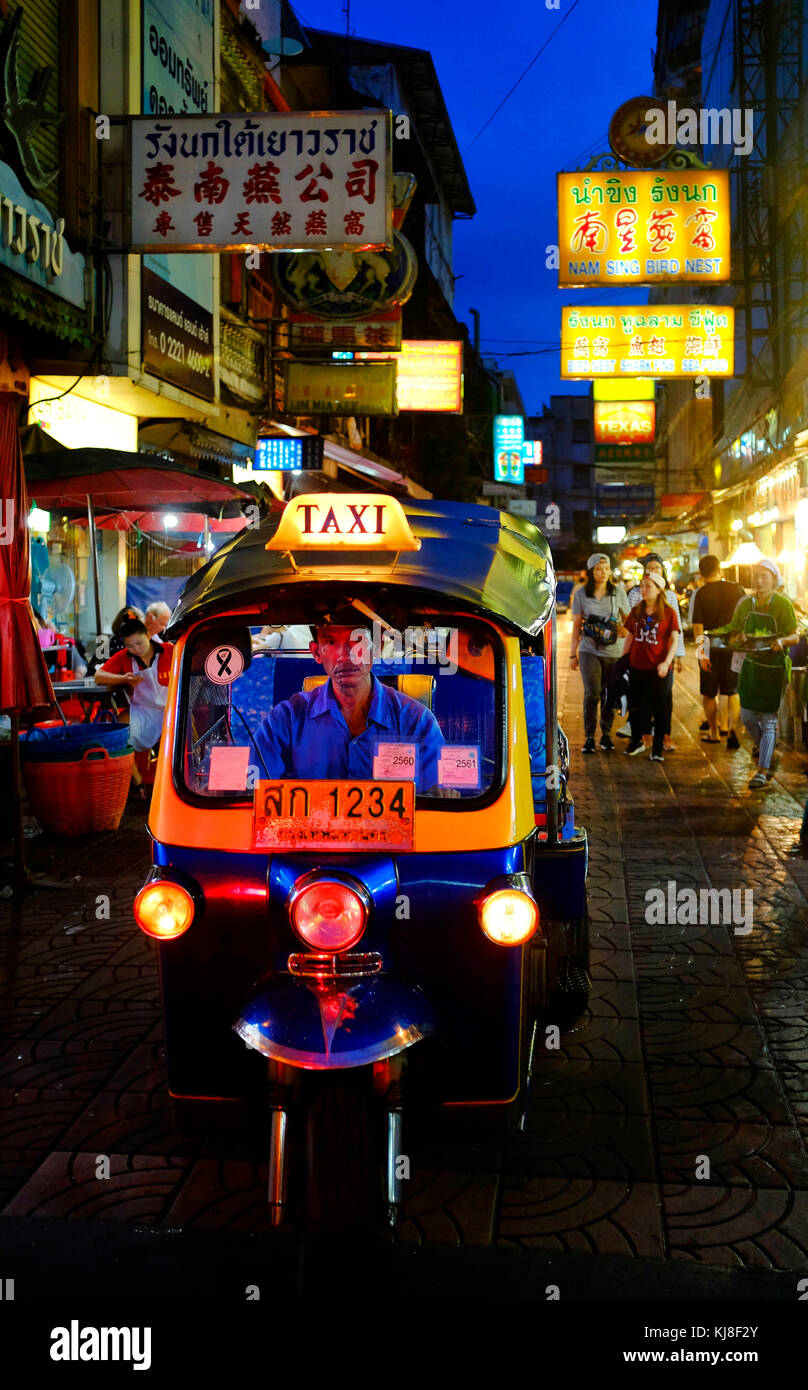 Tuk Tuk driver in Phadung Dao Road in Bangkok's Chinatown, Bangkok Thailand Stock Photo
