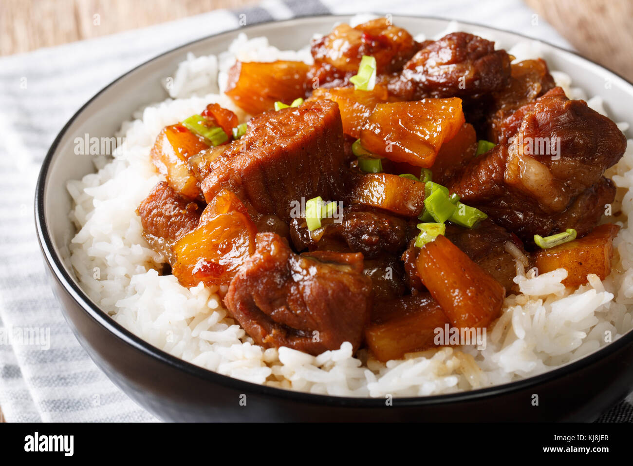 Tasty Filipino pork hamonado in pineapple juice with rice closeup in a