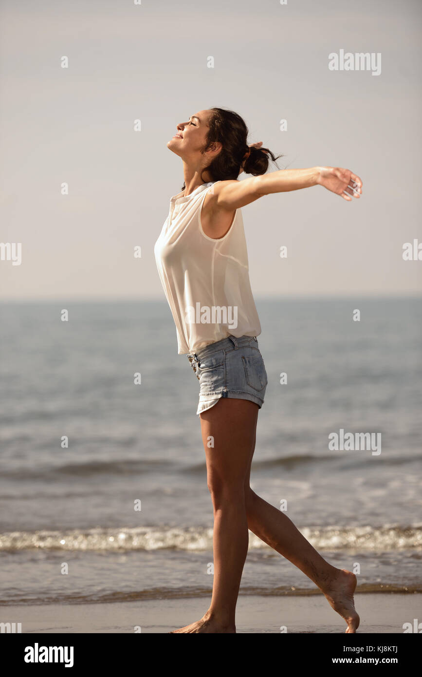 Happy Carefree Woman Enjoying Beautiful Sunset on the Beach Stock Photo ...