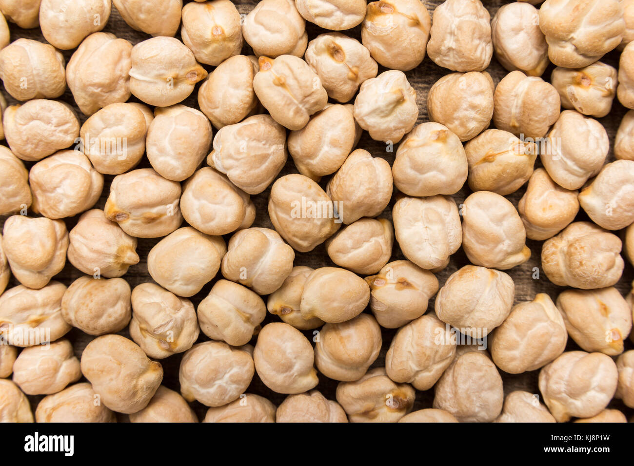 Cicer arietinum is scientific name of Chickpeas legume. Also known as Garbanzo bean, Chick Peas or Grao de Bico. Closeup of grains, background use. Stock Photo