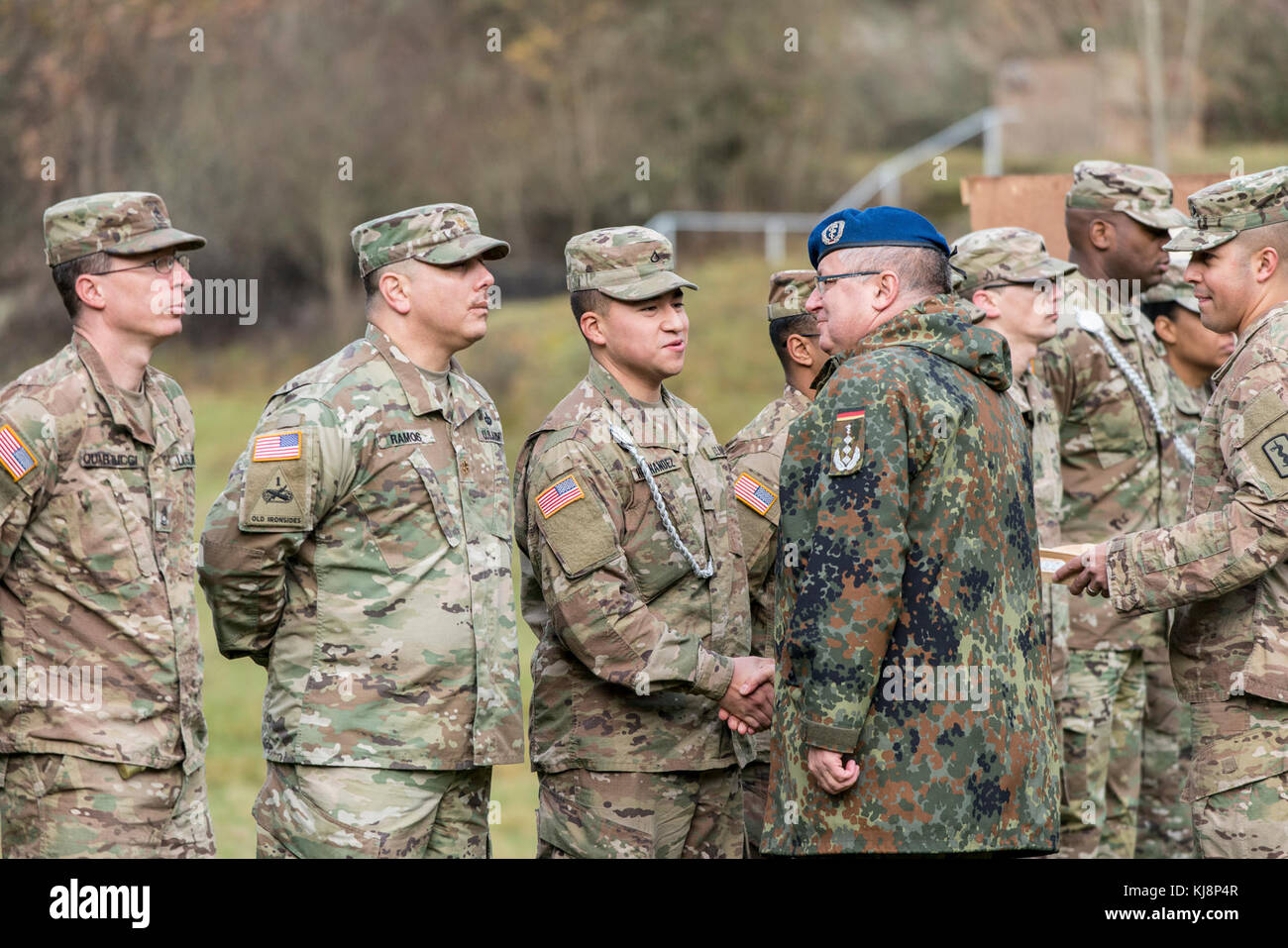 Col. Timothy G. Bosetti, commander of 30th Medical Brigade, in Sembach, Germany, and the commander from Sanitätsregiment 2, Oberstarzt Fritz Stoffregen, in Koblenz, Germany, present weapons qualification badges and Schützenschnur to Soldiers of their partner nation’s unit in a ceremony, Nov.15, 2017. During the two-day range event, U.S. Soldiers and their German counterparts fired pistols, machine guns and rifles to earn the partner country’s weapons qualification badges. (Photo taken by Erich Backes, VI Specialist, TSC Baumholder/ Released). Stock Photo