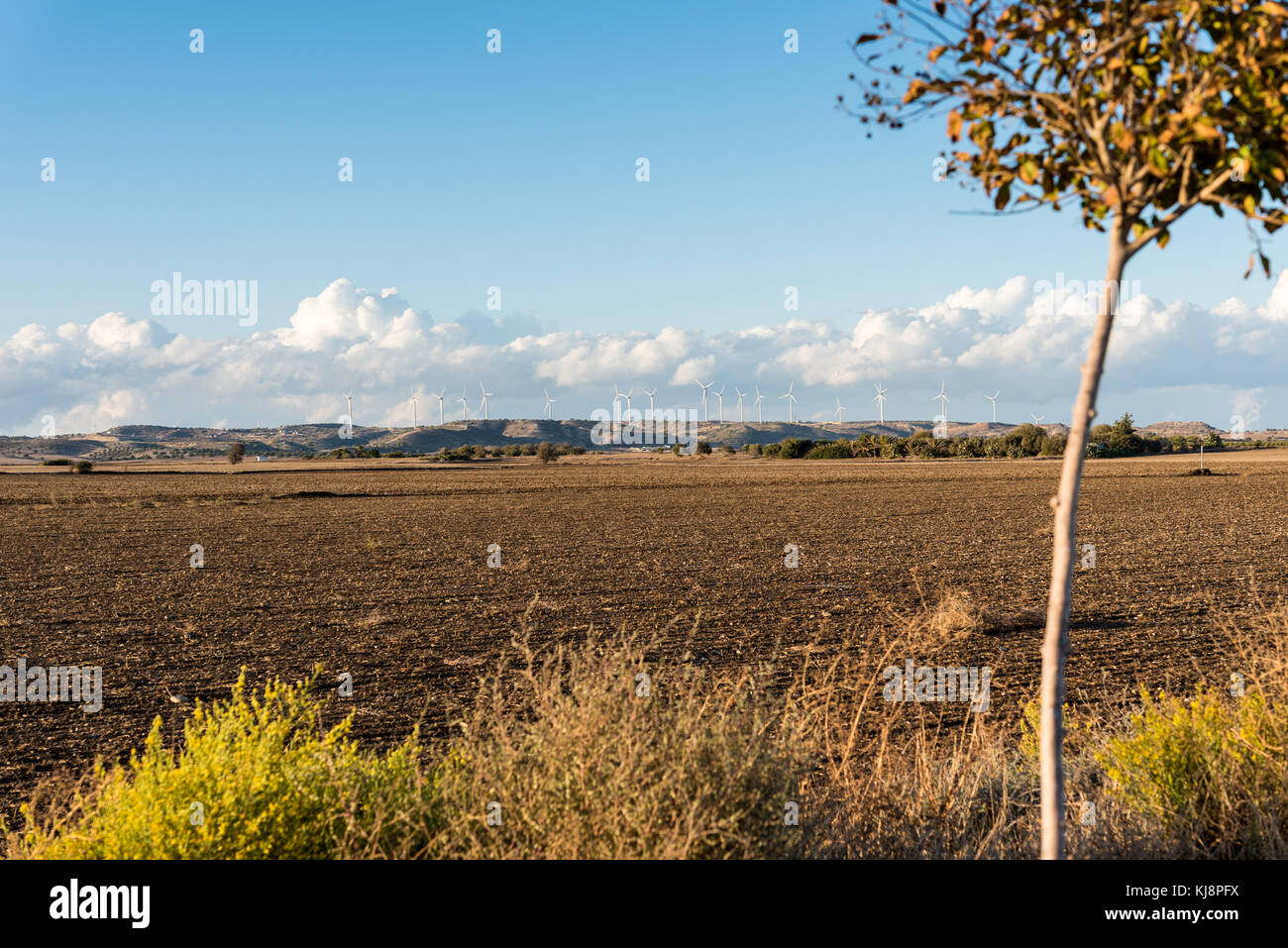 Agricultural land and wind turbines on a hill - cloudy day Stock Photo ...